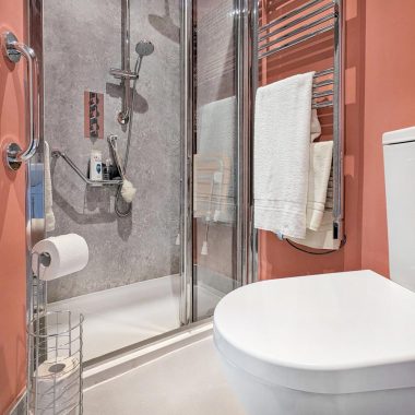 AFTER: Accessible ensuite with new walk-in shower, toilet, and sink