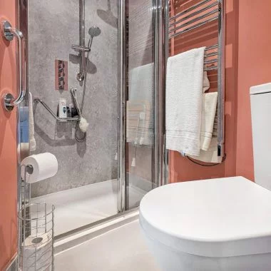 AFTER: Accessible ensuite with new walk-in shower, toilet, and sink