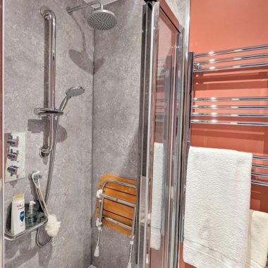 AFTER: Accessible ensuite with new walk-in shower, toilet, and sink