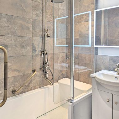 AFTER: Renovated bathroom with walk-in bath, accessible shower and new suite