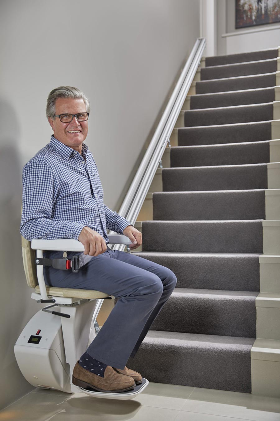 bespoke-home-stairlift-900a Older man sitting on a stair lift