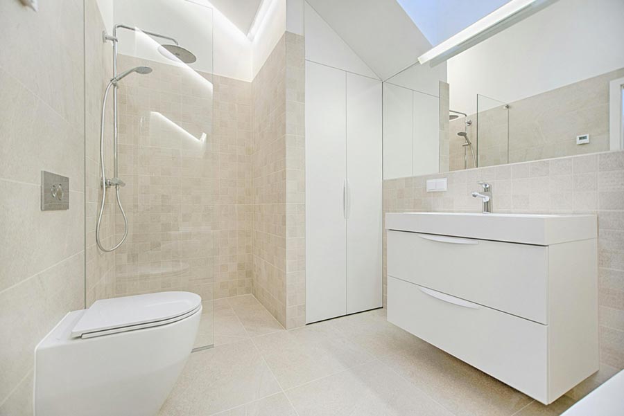 Light, tiled wet room with toilet